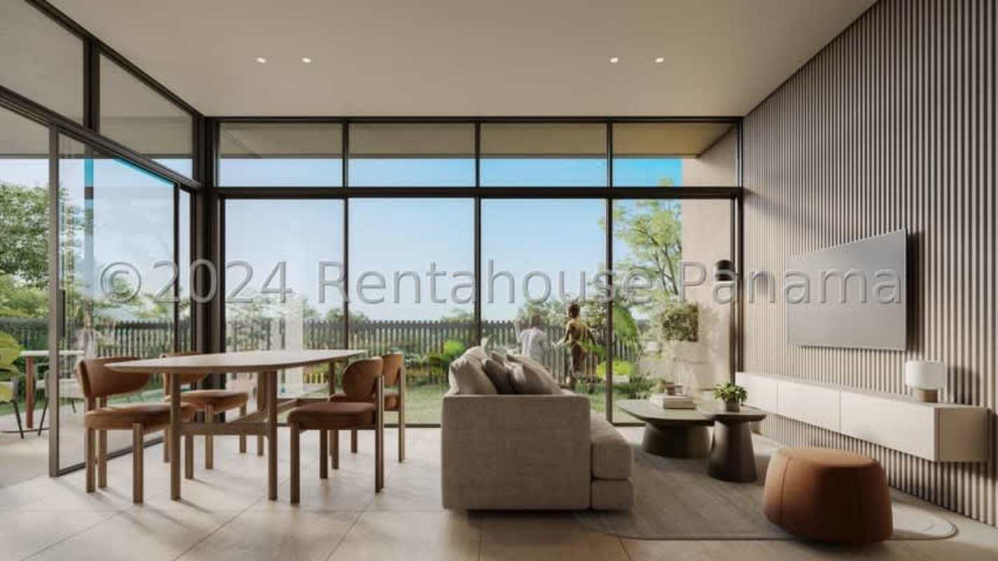 Spacious living and dining area with floor-to-ceiling windows opening to backyard
