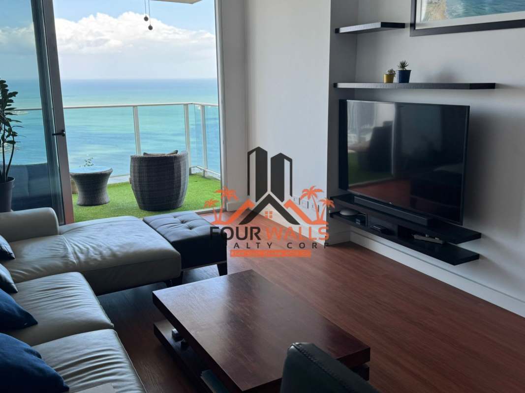 Open plan living-dining with large windows and ocean view balcony PH White Tower San Francisco Panama