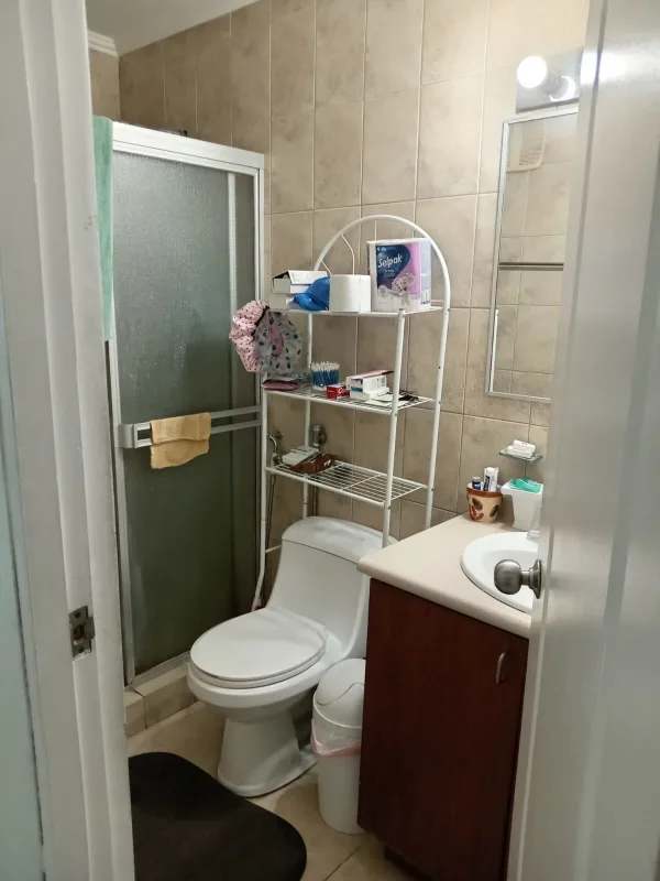 Contemporary bathroom with glass shower door and storage rack PH Condado Country Club Panama