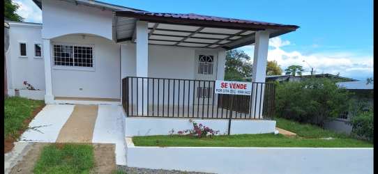 Front porch area with security bars and covered entrance in house for sale Las Lomas David