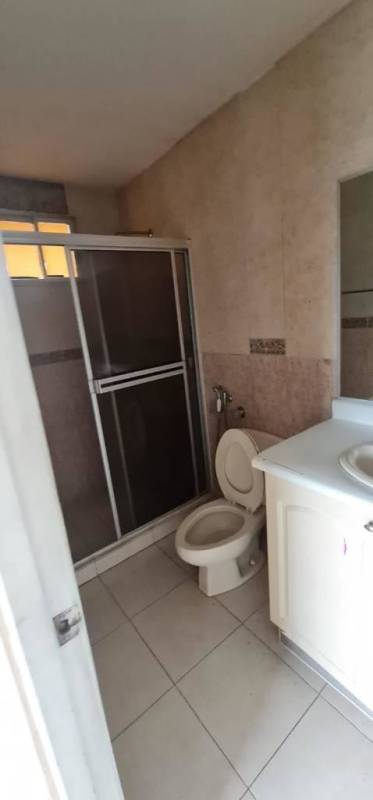 Bathroom featuring glass shower enclosure, vanity, ceramic tiles at Dorado Lake Panama City