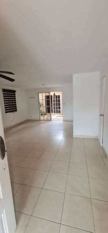 Minimalist blue bedroom with window and AC unit in Dorado Lake Residence Panama City