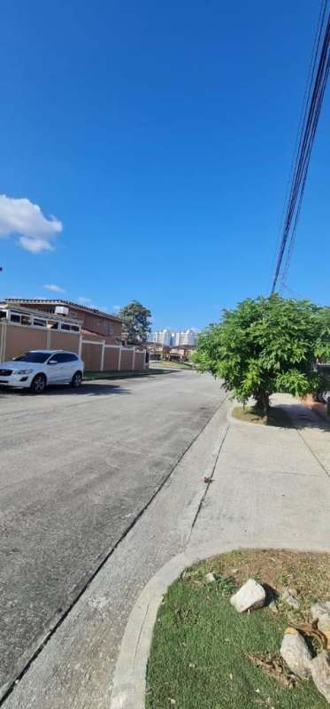 Quiet residential street in Dorado Lake El Dorado Panama City with parked cars and trees