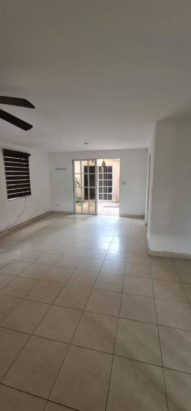 Empty living room with tiled floor, sliding doors opening to patio in Dorado Lake Residence Panama