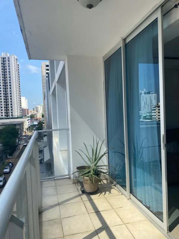 Modern apartment balcony with glass railing, panoramic skyline city view at PH The Palm Obarrio Panama City.