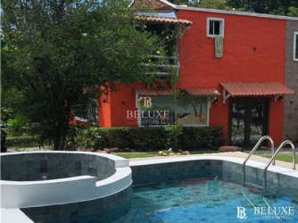 Exterior view two-story country beach home with balcony in San Carlos Panama