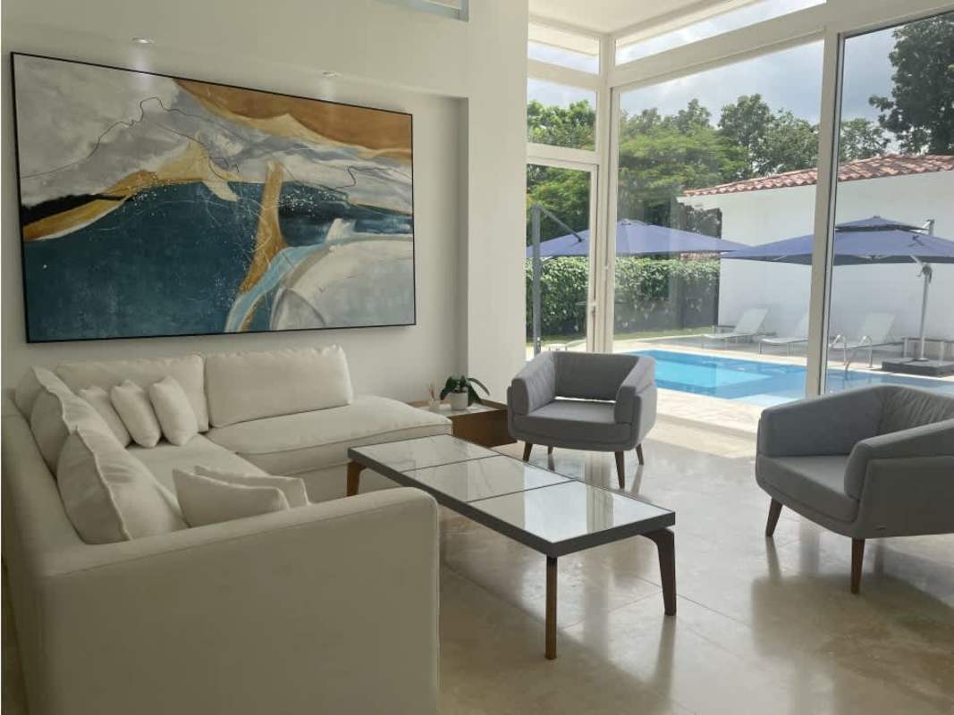 Calm minimalist bedroom with upholstered bed and tiled floors in Santa Maria Panama