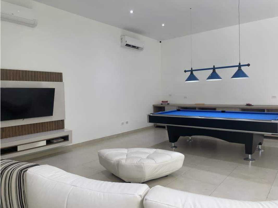 Luxurious master suite with balcony access, textured ceiling and chandelier in Santa Maria estate Panama