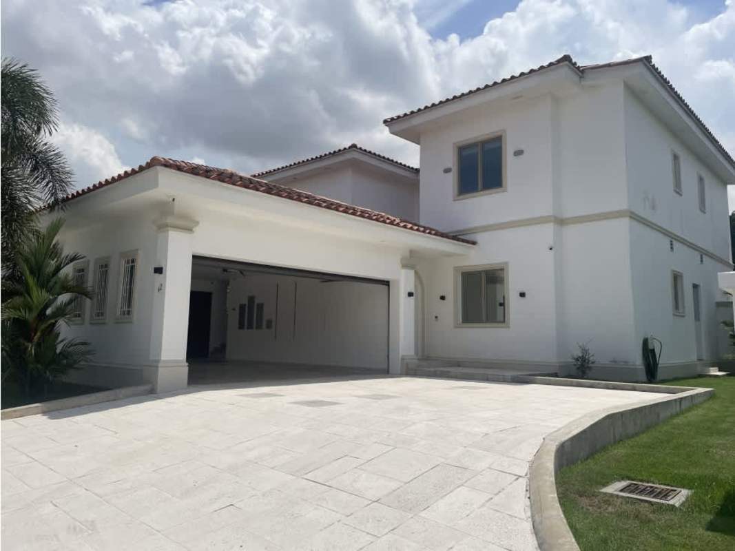 Grand estate two-story exterior with tile roof and driveway in Santa Maria Panama