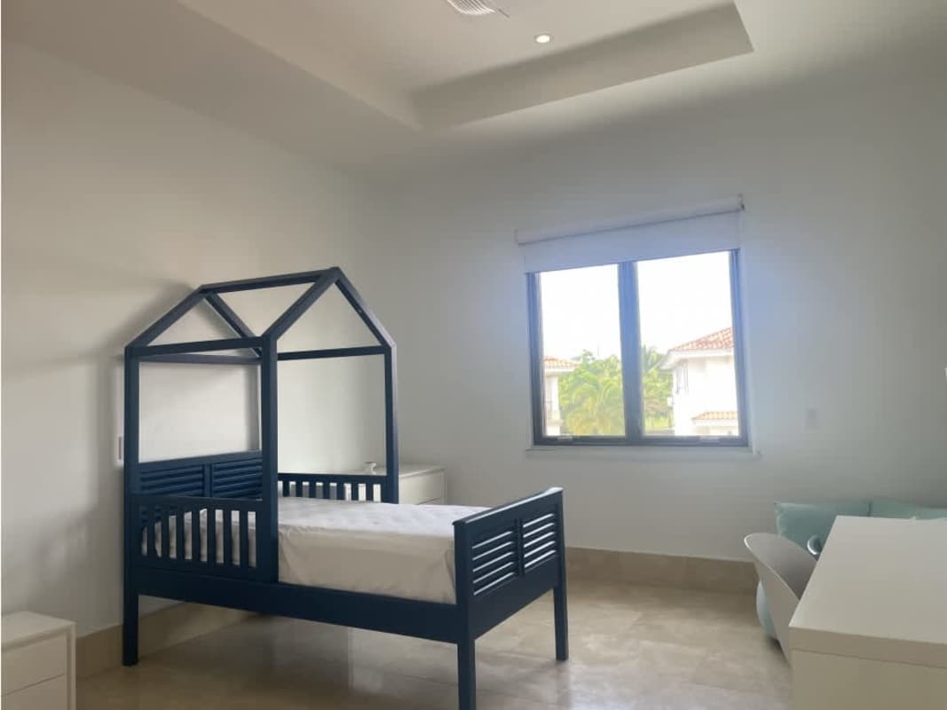 Luxury home backyard with blue pool, sun deck, lush landscaping in Santa Maria Fairway Estates Panama