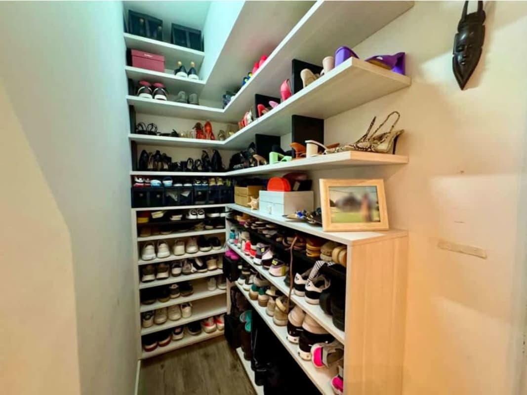 Organized walk-in closet shoe shelves and storage in Yacht Club Panama apartment