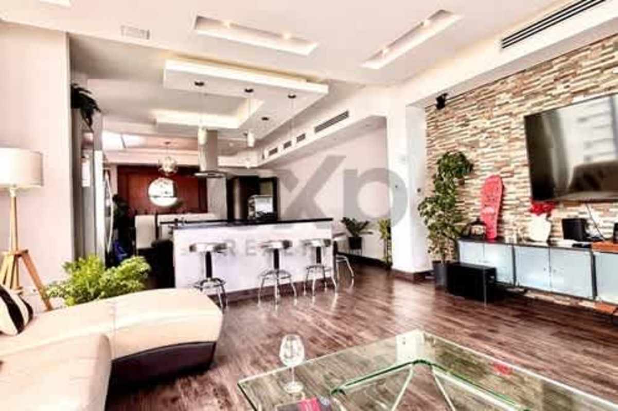 Dining space with large glass windows overlooking ocean at PH Rivage Avenida Balboa Panama City