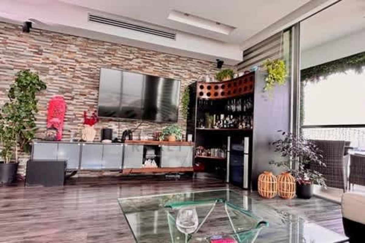 Modern living room with balcony access, ocean views, sectional sofa in PH Rivage Panama