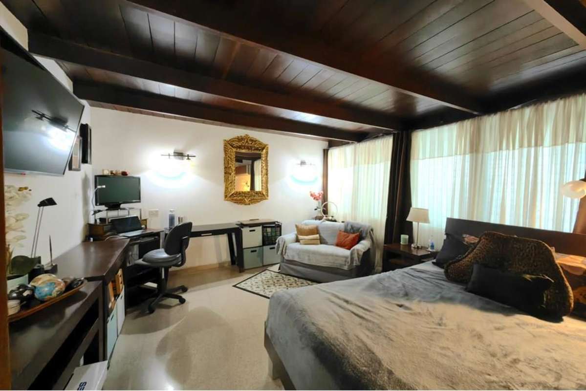 Traditional living room with wood ceiling, large windows, vintage decor mid-century house Obarrio Panama