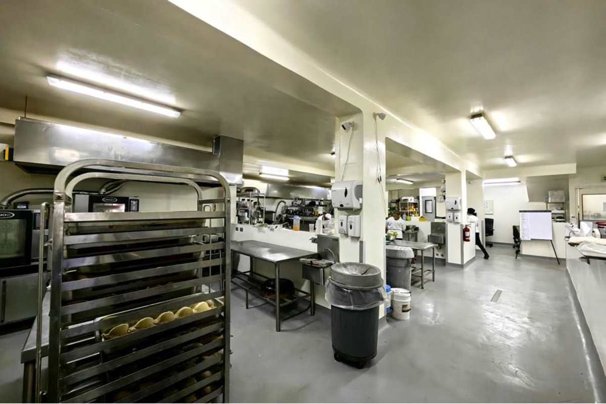 Equipped industrial kitchen with prep tables, shelving, stainless steel appliances in San Francisco Panama