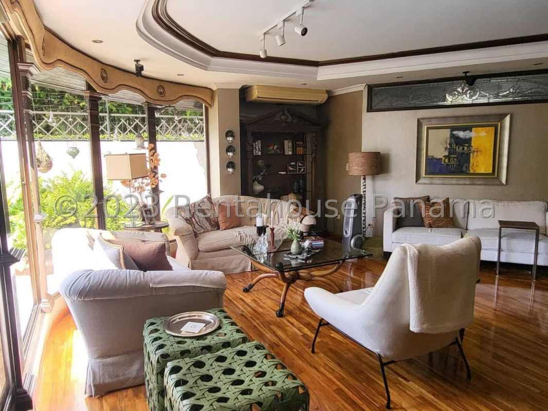 Dining area with large garden-facing windows and elegant decor in El Carmen Panama