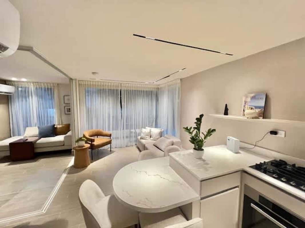 Bright minimalist condo living room with balcony at PH Armonía Bella Vista Panama City