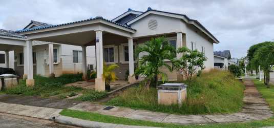 Front garden with covered driveway and porch in corner house for sale in La Chorrera Panama