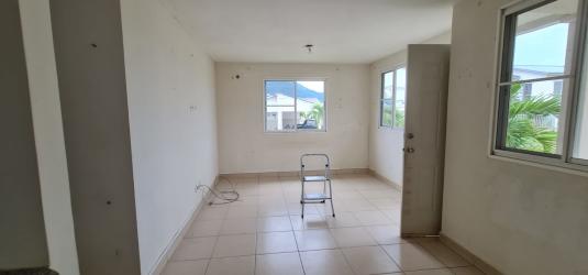 Living space with natural light and tiled floors inside corner house La Chorrera Panama