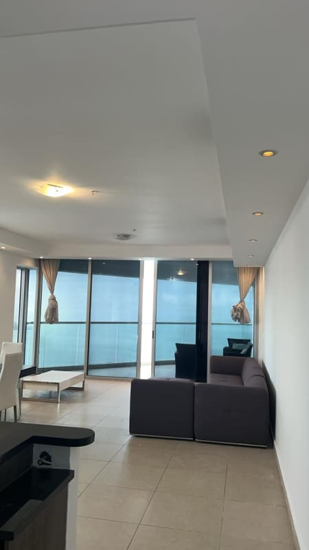 Bright open living dining area with ocean view balcony in PH Rivage Panama City