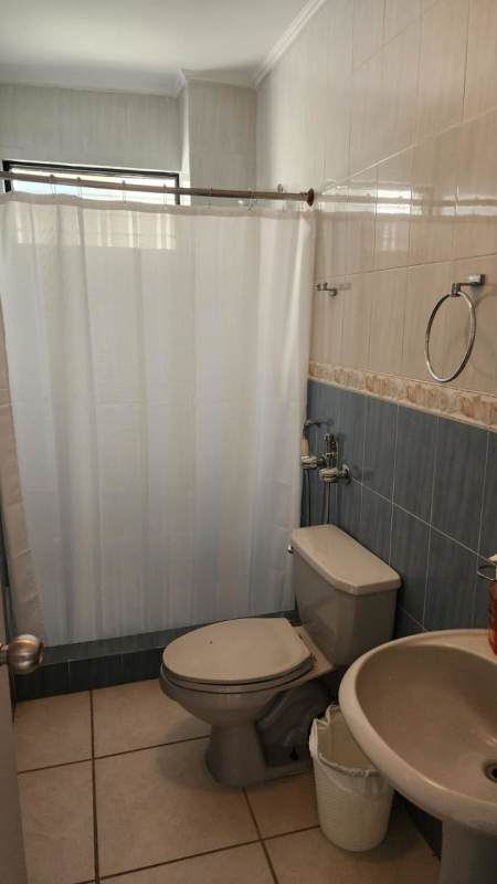 Compact bathroom with tiled walls, pedestal sink, shower PH Villa de las Fuentes Panama