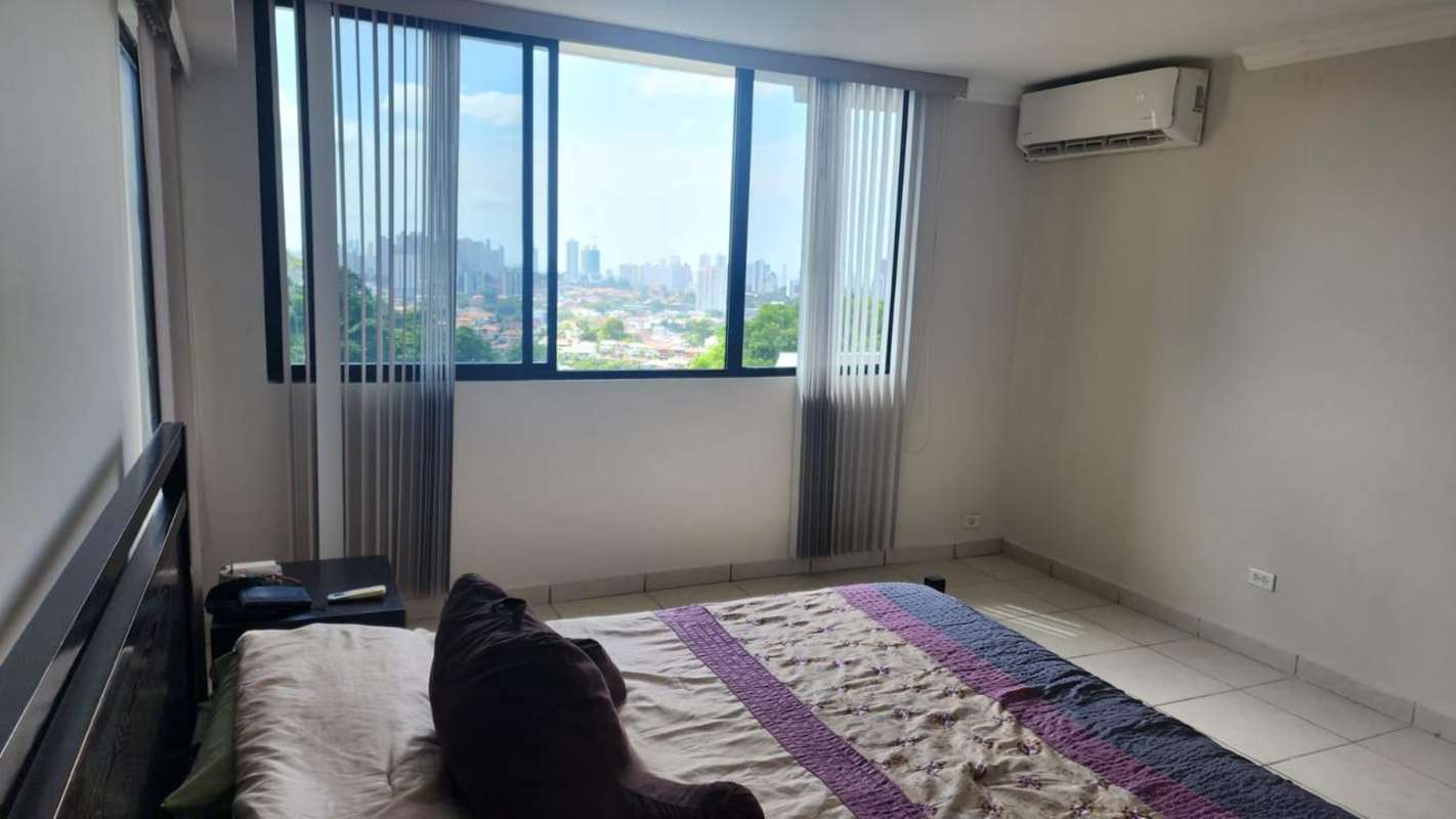 Living dining open-plan with large window city skyline tile floor contemporary furnishings PH Villa de las Fuentes