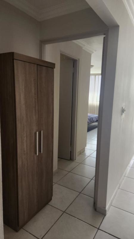 Stylish living dining with beige sofa glass table yellow bench vertical blinds Villa de las Fuentes Panama