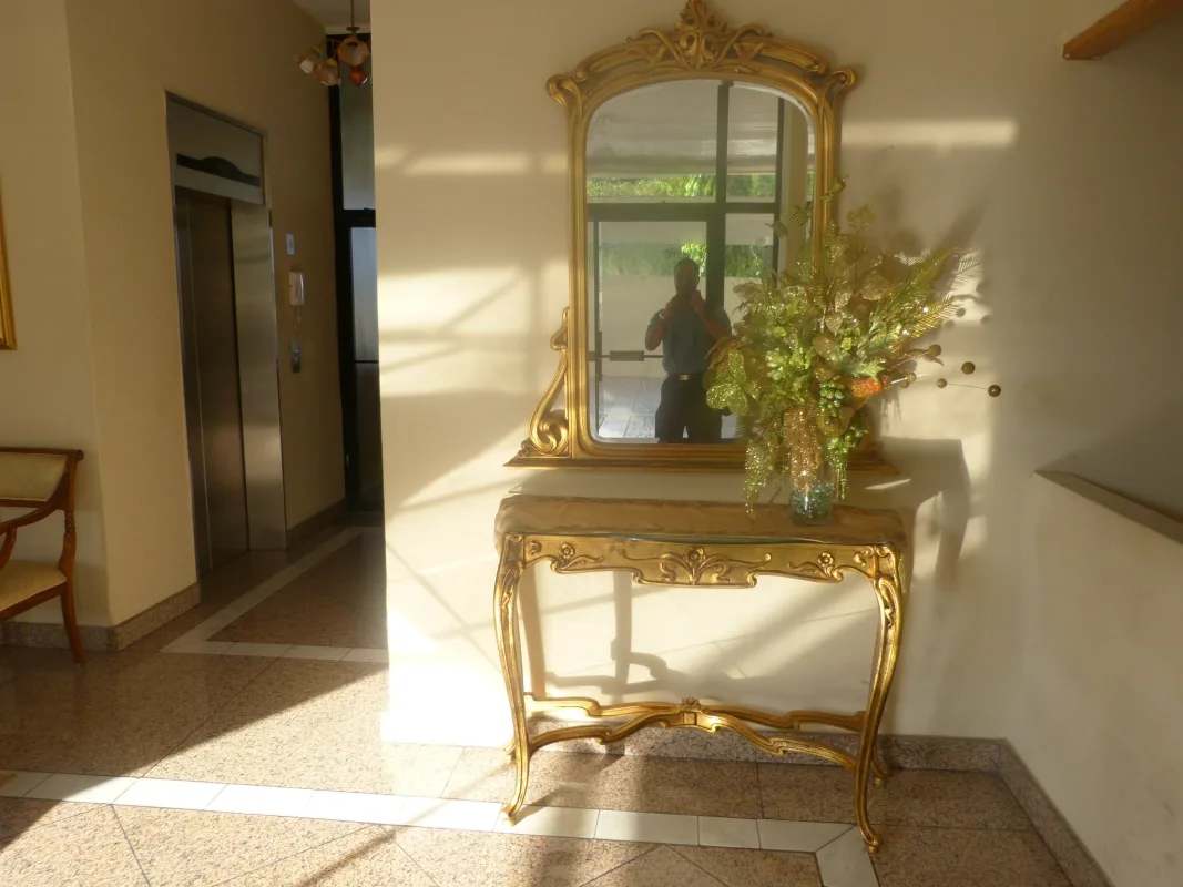 Lobby area with ornate mirror console table flower arrangement and elevator Villa de las Fuentes Panama