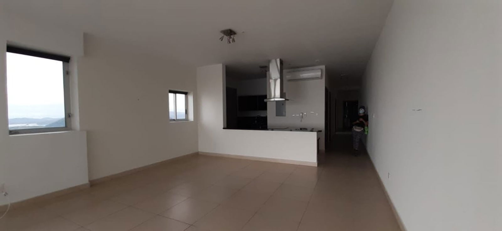 Contemporary kitchen with island cooktop, black countertop, open plan design PH Rivage
