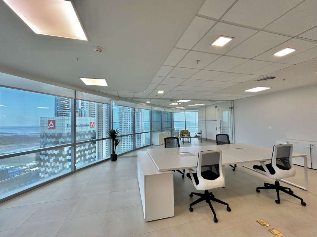 Office workspace with glass partitions and large city skyline views at PH Financial Park Costa del Este Panama