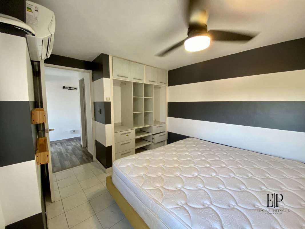 Bedroom featuring striped accent wall, AC, built-in closet at PH Peach Tree in Hato Pintado Panama City
