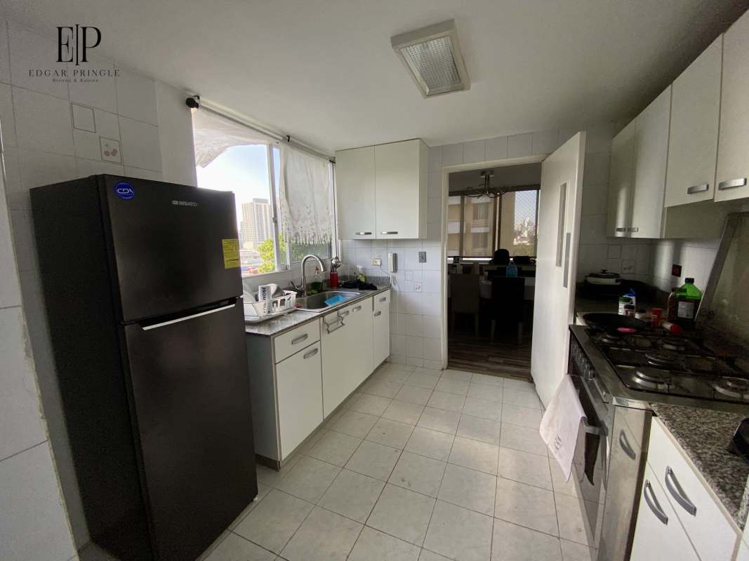 Apartment kitchen with granite countertops, gas stove, white cabinets PH Peach Tree Hato Pintado Panama City
