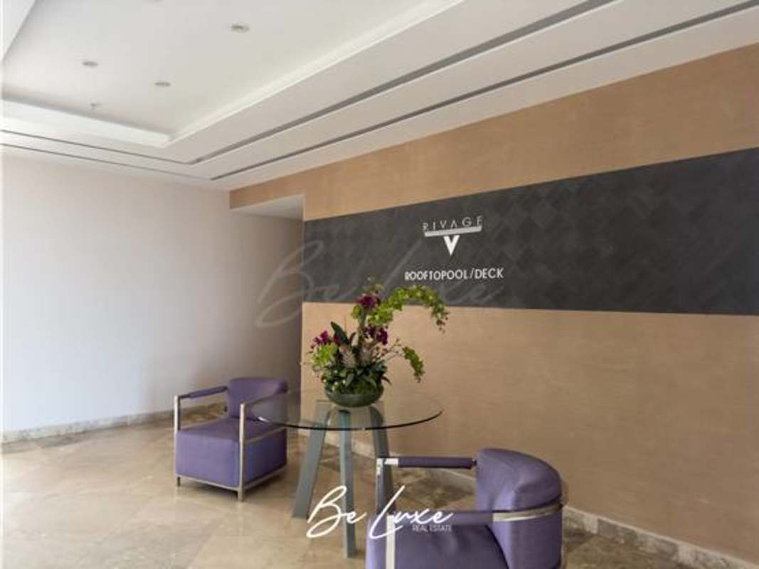 Reception area lobby with signage to rooftop pool deck in Rivage Tower