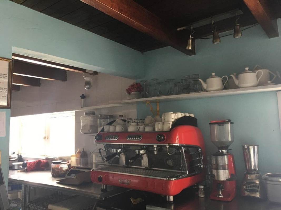 Espresso machine and coffee grinder in rustic kitchen station of cafe Casco Viejo Panama