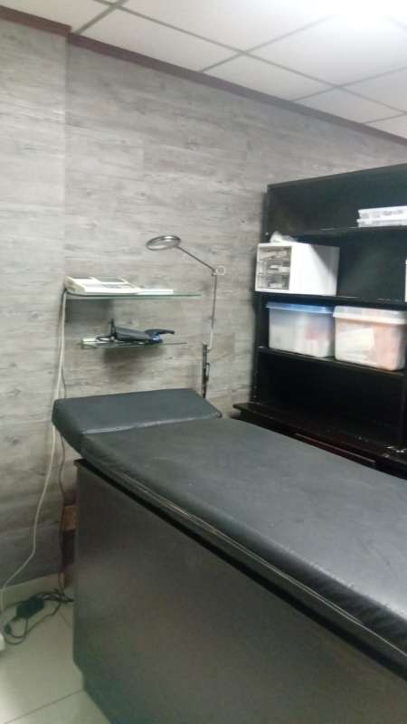 Consultation room with exam bed shelves and lighting at Policlinica San Fernando Panama