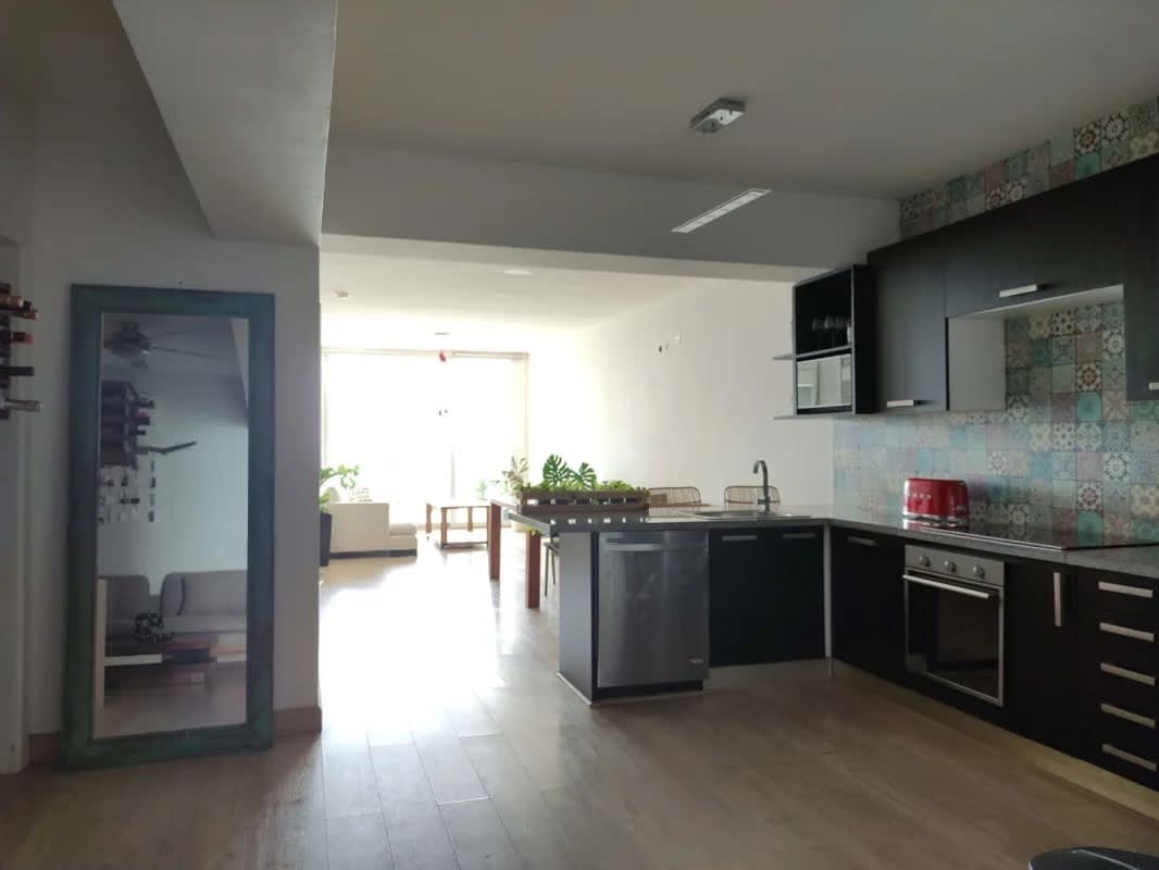 Open-plan kitchen with modern design connects to bright living space ocean view PH White Tower Panama
