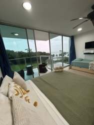 Modern bathroom with glass enclosed shower in oceanfront studio at PH Bala Beach Maria Chiquita Panama