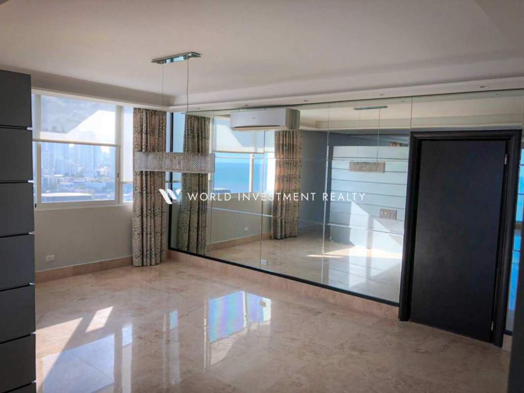 Master bedroom with large window, ocean views, marble floor at PH Puntarenas Coco del Mar Panama