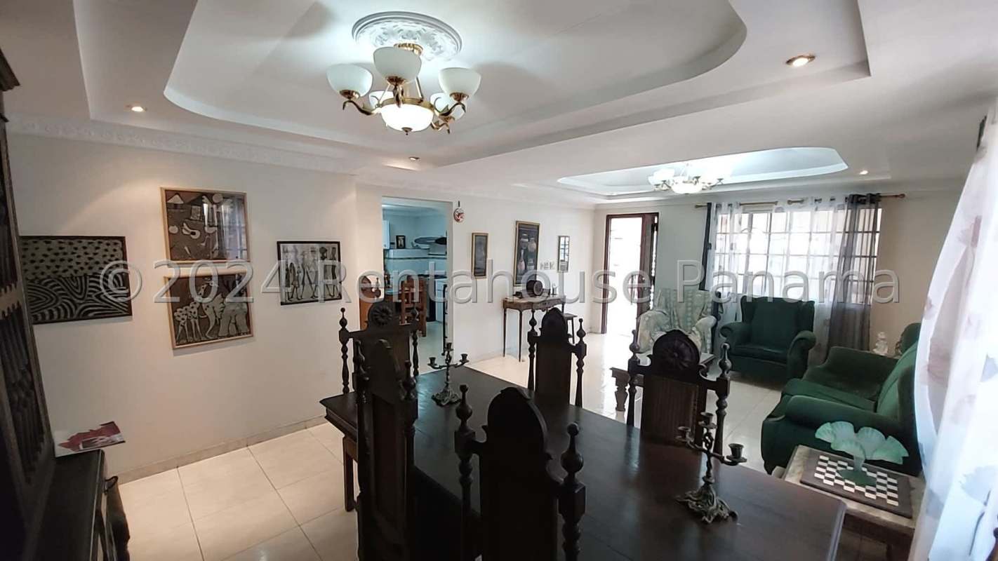 Spacious kitchen with white cabinets, tile floors, dining table in Tierra Alta Panama