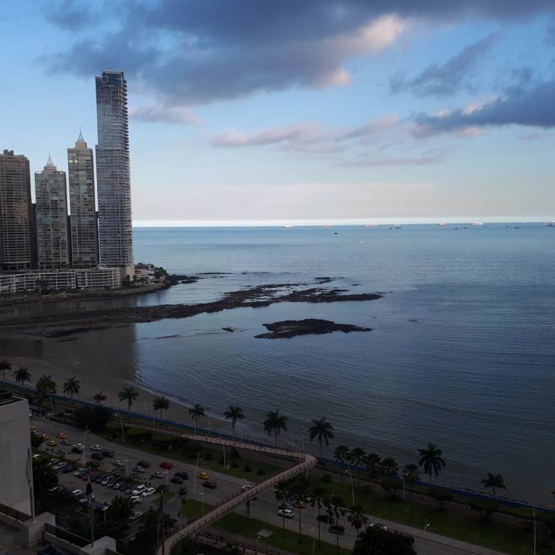 Spacious living room with large windows providing ocean and skyline views in PH Miramar on Avenida Balboa