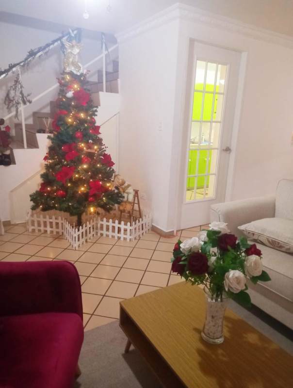 Living room with Christmas decorations, furniture and staircase in Condado del Rey Panama City home
