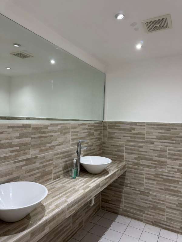 Elegant modern bathroom with double sinks at PH Torre BAC full floor office Panama