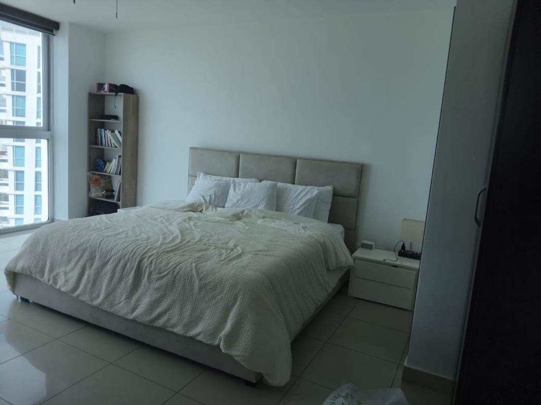 Modern master bedroom with floor-to-ceiling ocean view windows in PH Waterfalls Coco del Mar Panama City