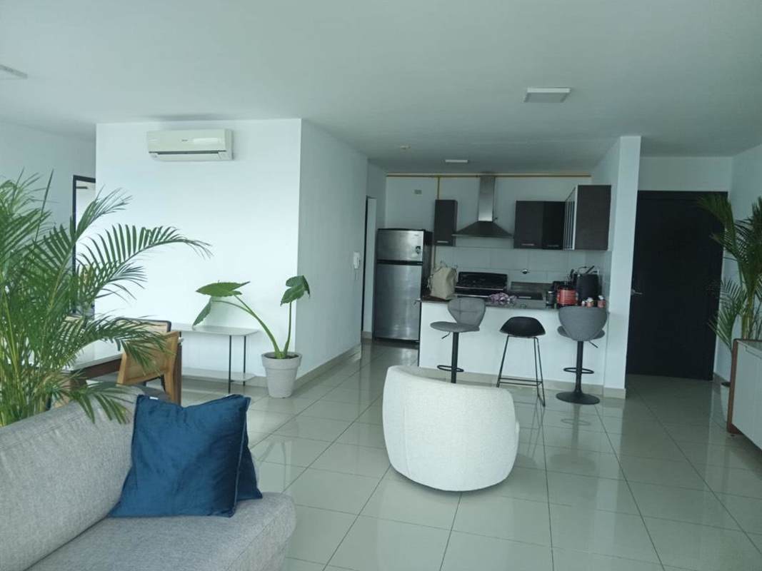 Modern kitchen with island and open-plan living room with natural light in PH Waterfalls Coco del Mar Panama