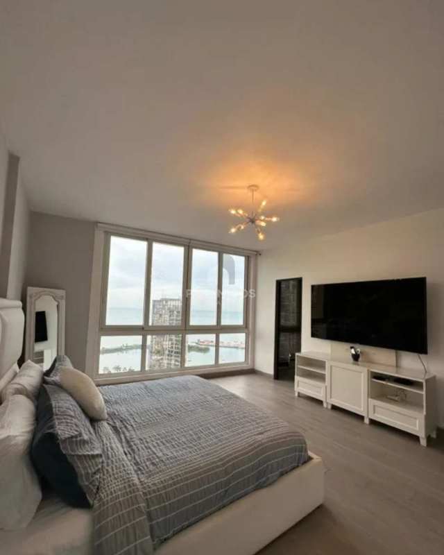 Bedroom with large windows showing Pacific Ocean skyline at PH Marina Park Bella Vista Panama City