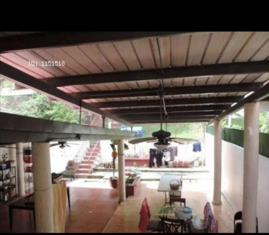 Spacious backyard covered patio with dining space ceiling fans in Villa de las Fuentes house