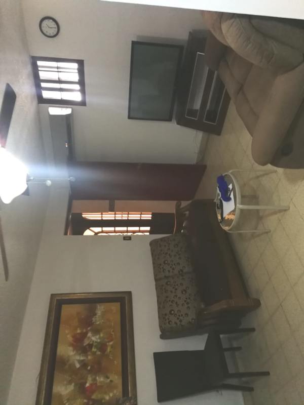 Modern cabinetry granite countertops and dining area in Villa de las Fuentes house Panama