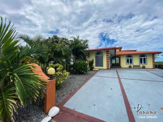 Mediterranean entryway with double hand-carved doors and turquoise accent wall luxury beachfront villa Chiriquí Panama