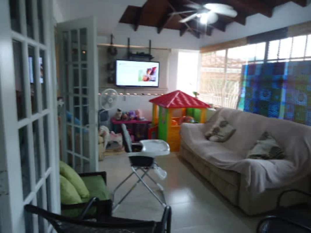 Traditional kitchen with granite counters, oven, wood cabinets in Dos Mares house Panama City