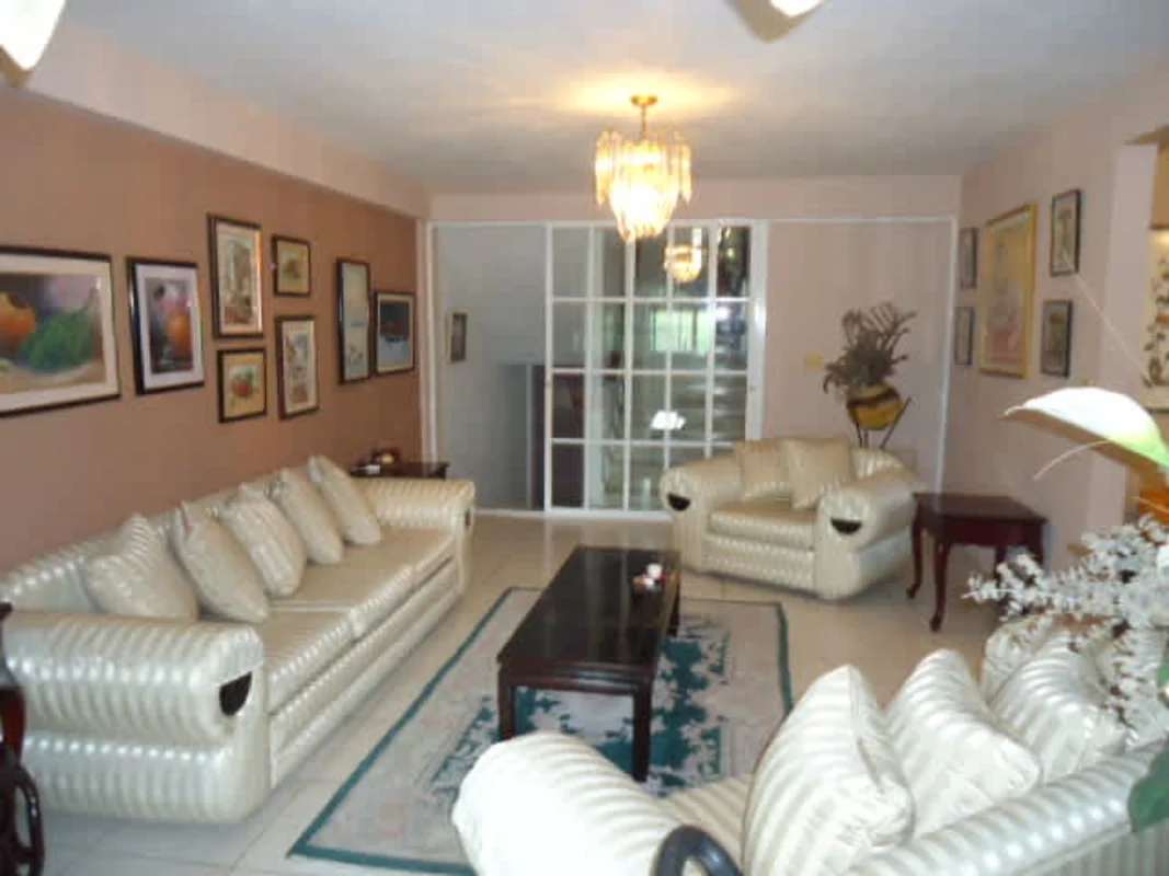 Traditional dining area with wooden table, chandelier, air conditioning in Dos Mares house Panama